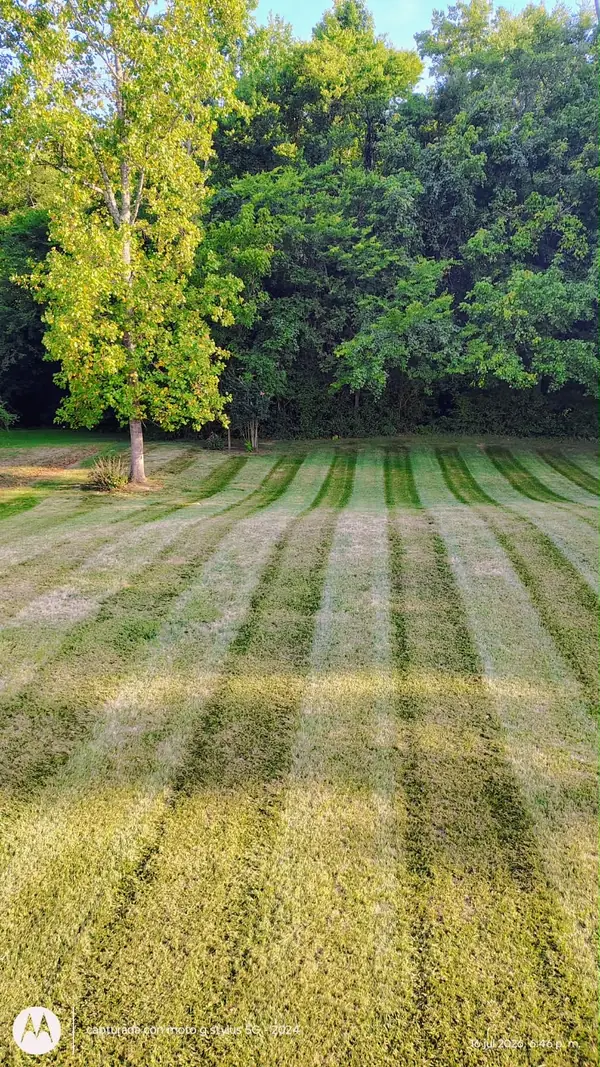 Summer lawn mowed in stripes by Pastor Landscaping